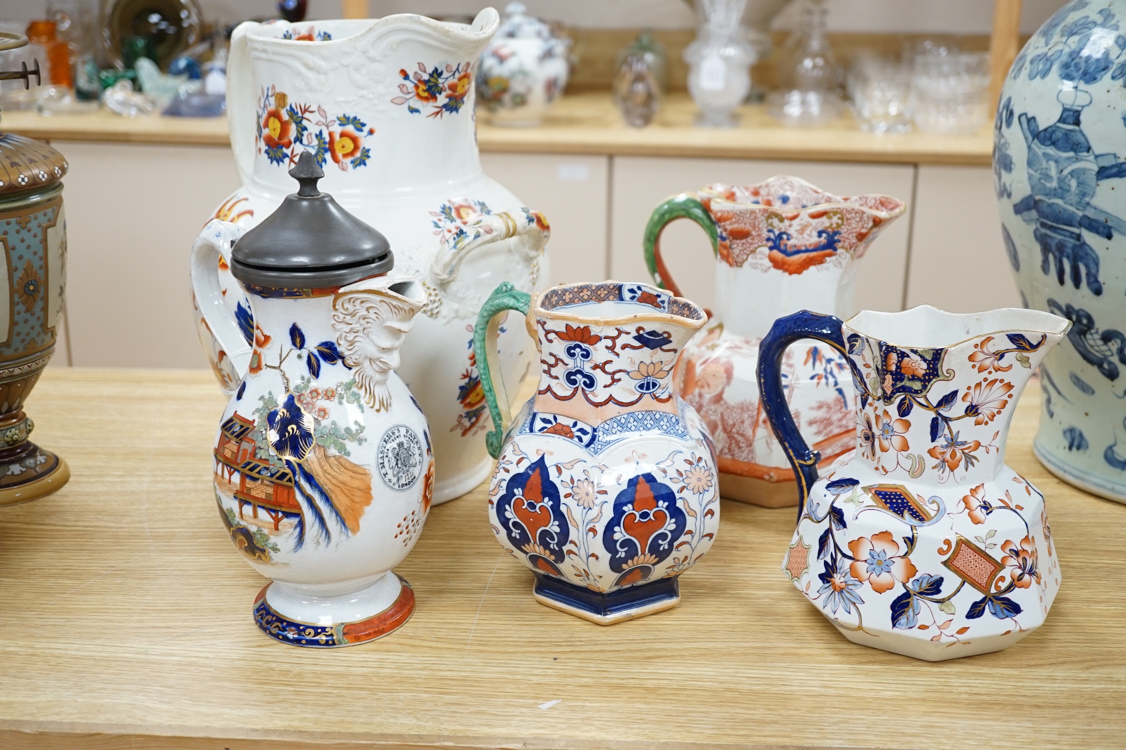 Five ironstone jugs to include a pewter mounted example, largest 36cm high. Condition - varies, poor to fair